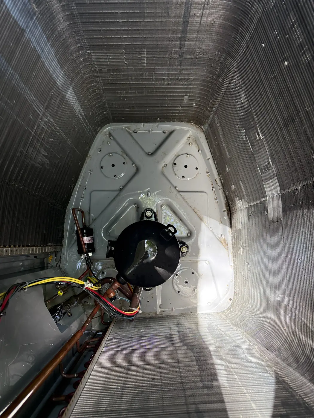 The same blower compartment cleaned out with the blower assembly visible
