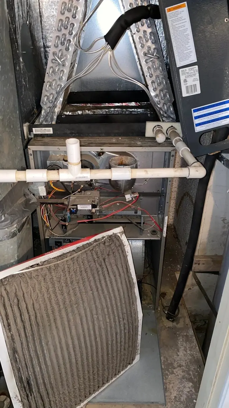 Open furnace and evaporator coil with the filter removed during inspection
