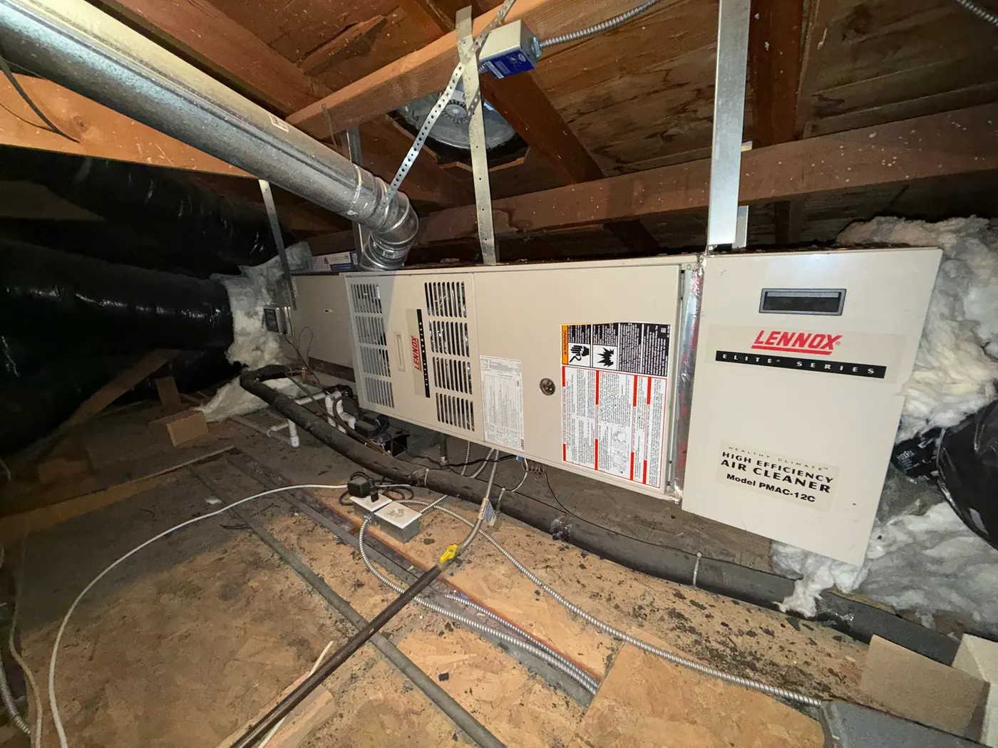 Newly installed Lennox furnace and air handler in an attic with connected duct