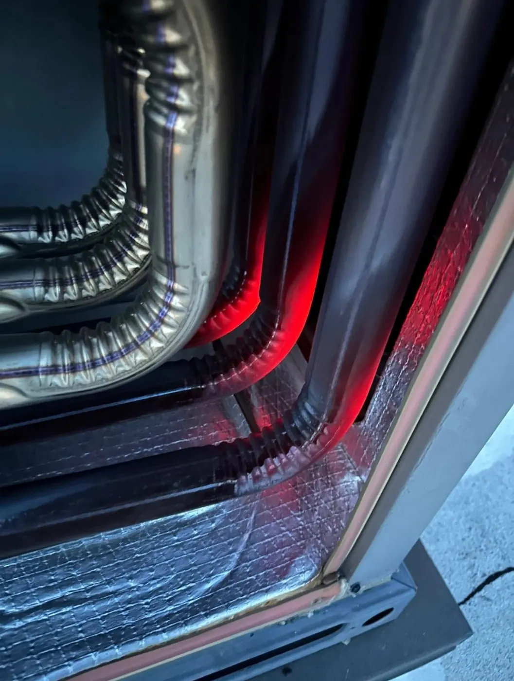 Sheet metal plenum and insulated duct transition at an indoor unit