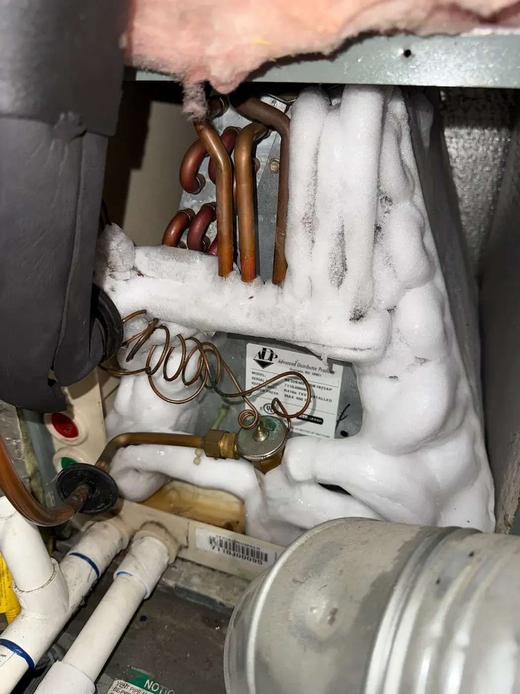 Refrigerant lines and suction piping covered in ice at an indoor unit