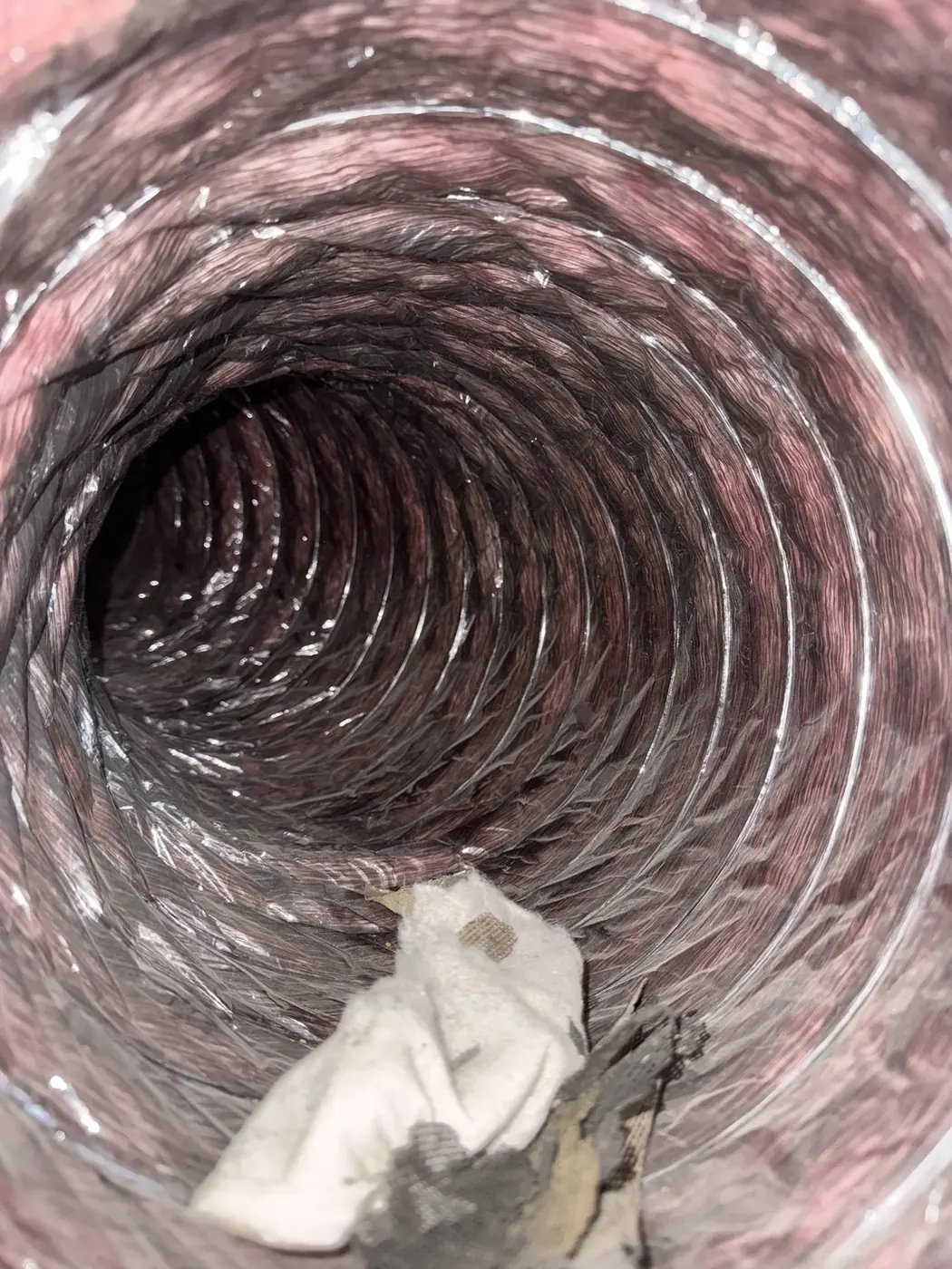 Interior view along a flexible duct run during a duct inspection